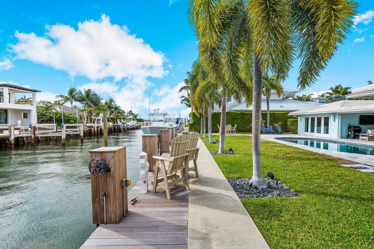 1041 Gulfstream Way Singer Island, FL 33404 - Photo 31 of 41 a view of a house with swimming pool and a back yard