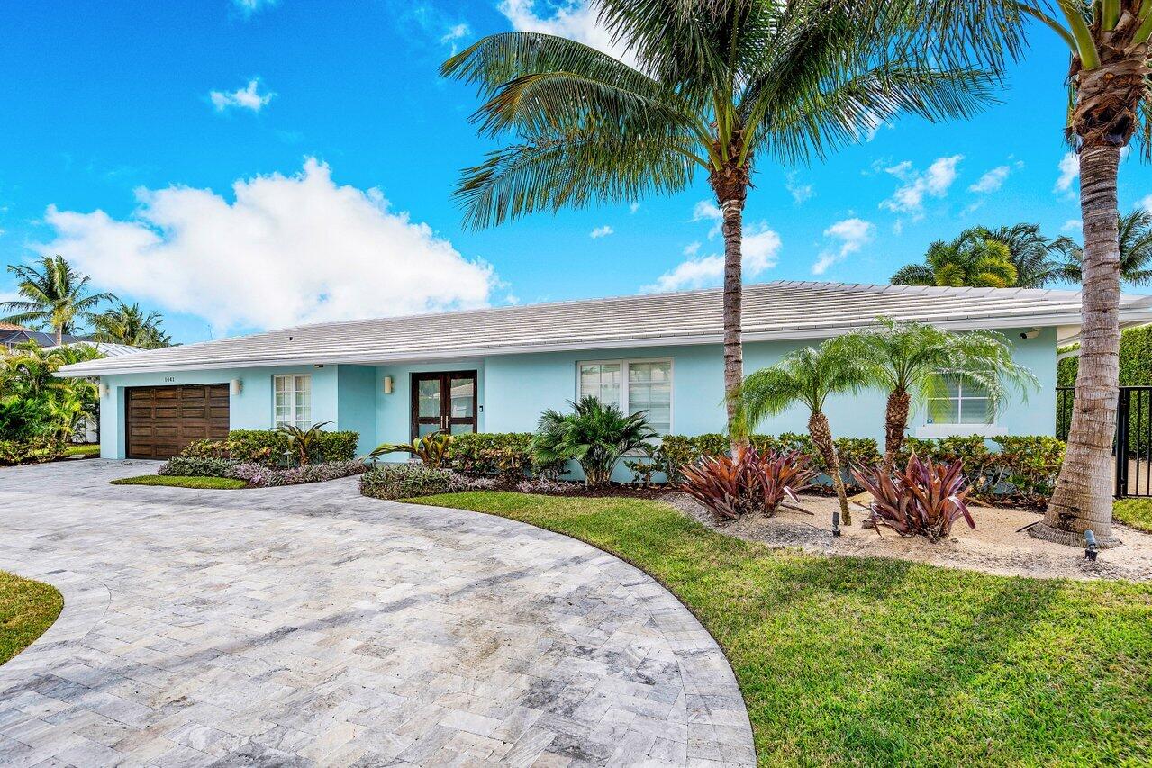 1041 Gulfstream Way Singer Island, FL 33404 - Photo 5 of 41 a front view of house with yard and outdoor seating