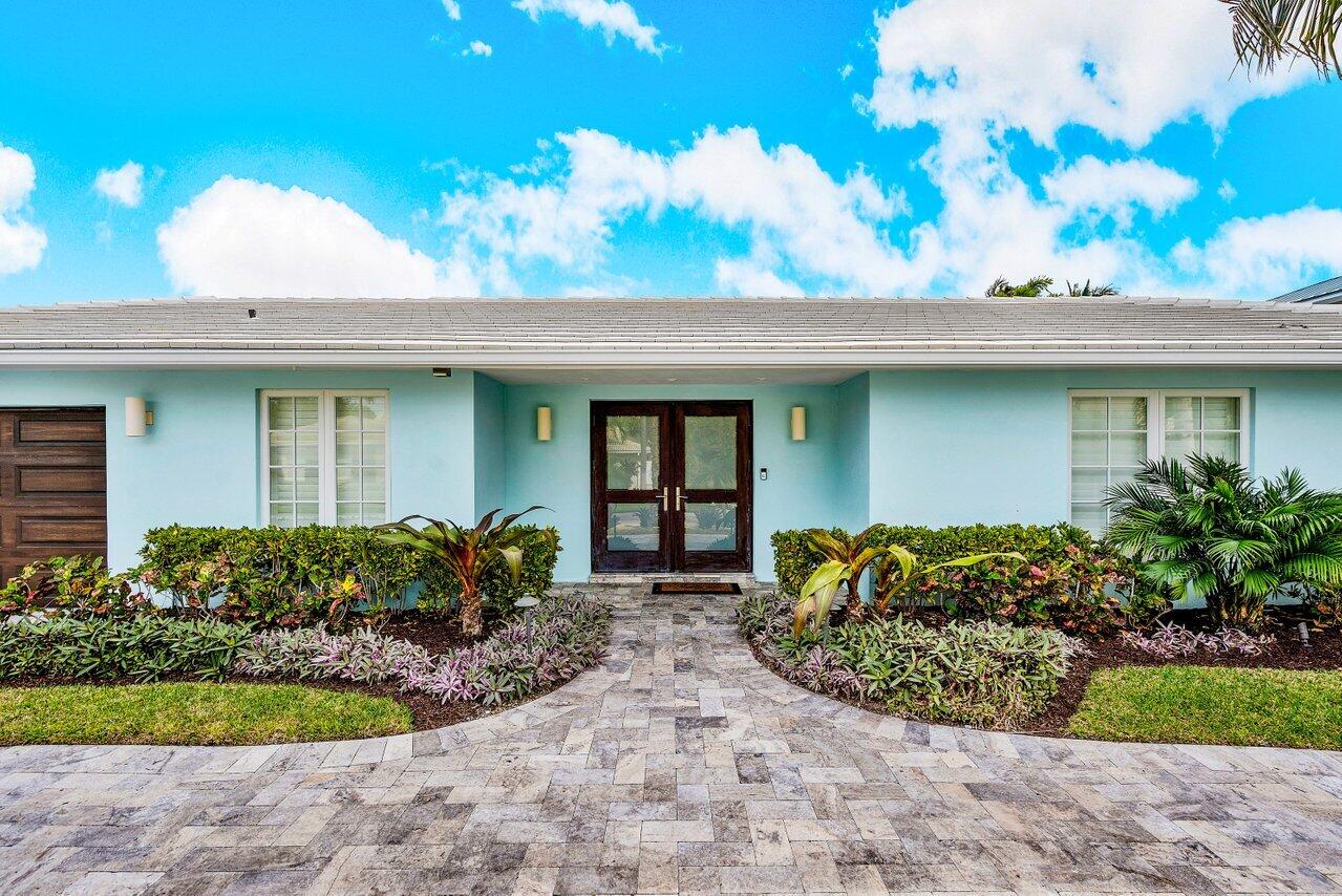 1041 Gulfstream Way Singer Island, FL 33404 - Photo 6 of 41 a front view of a house with garden