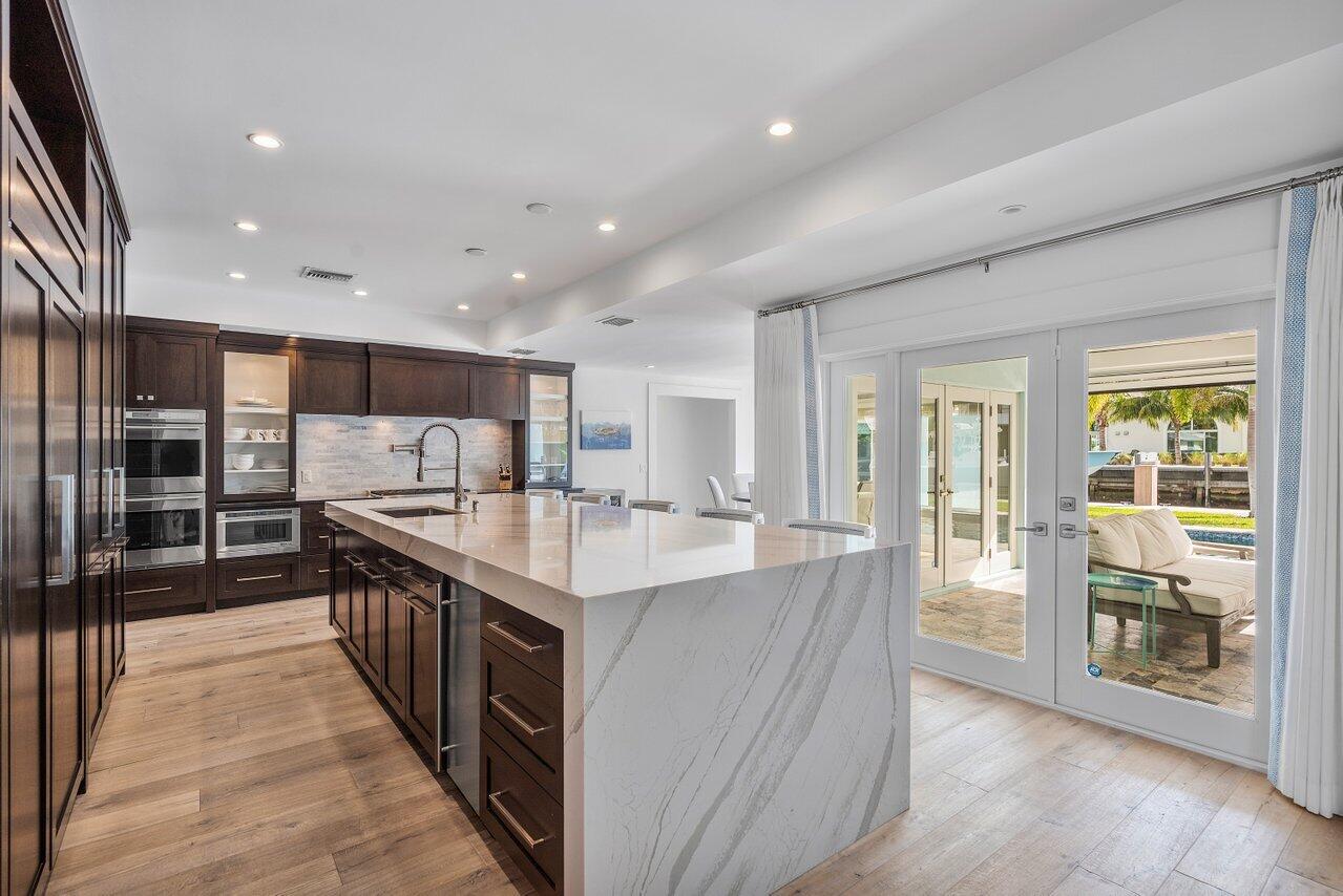 1041 Gulfstream Way Singer Island, FL 33404 - Photo 9 of 41 a large kitchen with stainless steel appliances granite countertop a large counter top a stove and a refrigerator