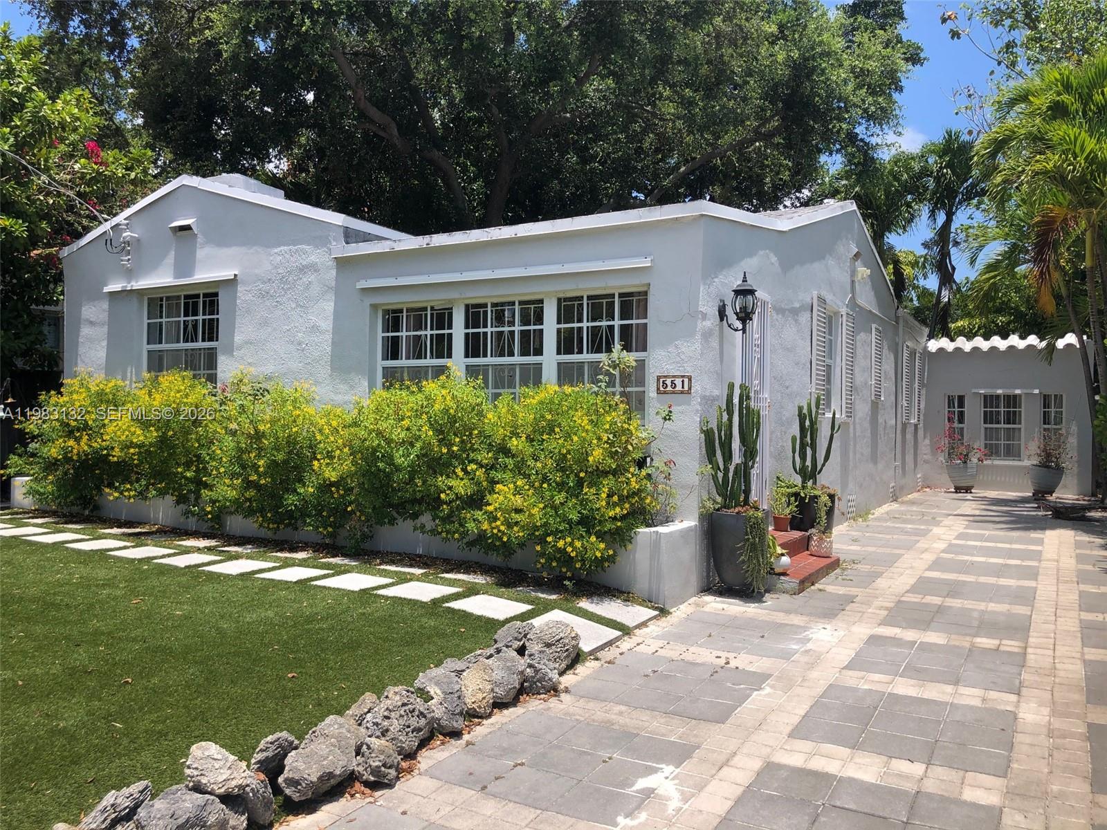 a front view of a house with garden