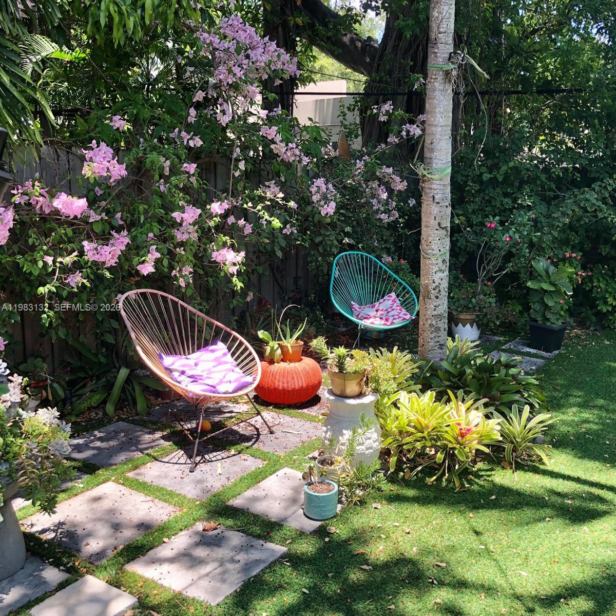 551 Northeast 69th Street, Unit 1&2 Miami, FL 33138 - Photo 12 of 15 a backyard of a house with lots of potted plants