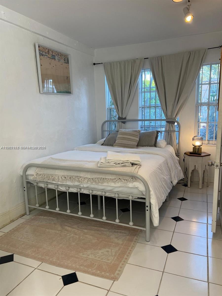 551 Northeast 69th Street, Unit 1&2 Miami, FL 33138 - Photo 14 of 15 a bedroom with a bed and a view of windows