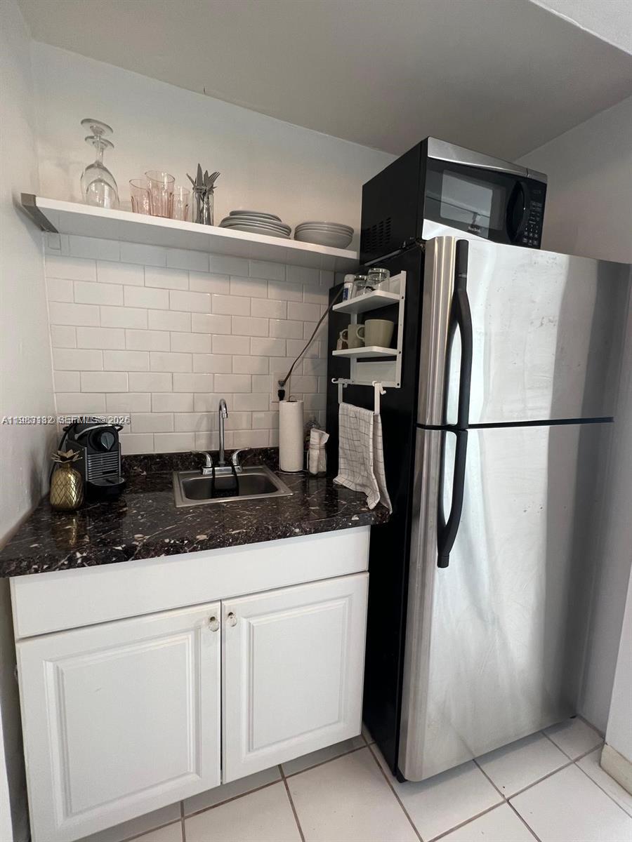 551 Northeast 69th Street, Unit 1&2 Miami, FL 33138 - Photo 15 of 15 a kitchen with stainless steel appliances a sink and cabinets