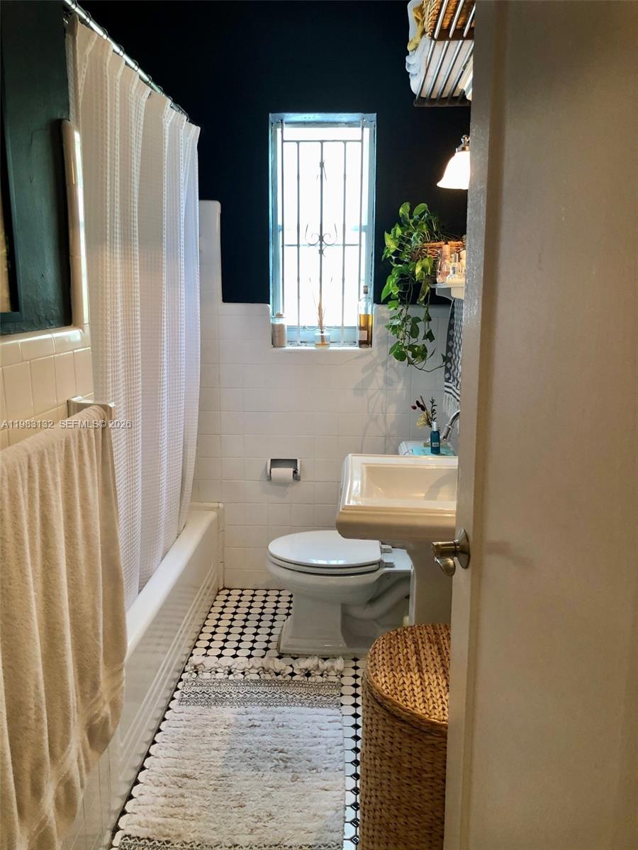 551 Northeast 69th Street, Unit 1&2 Miami, FL 33138 - Photo 7 of 15 a bathroom with a sink toilet and shower