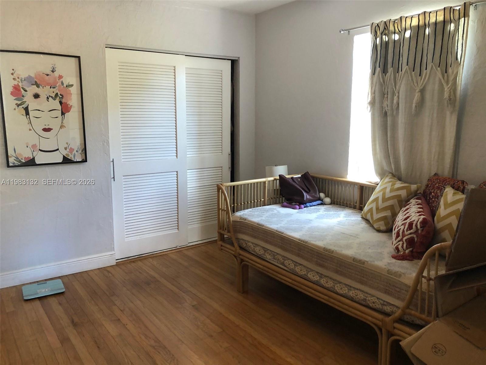 551 Northeast 69th Street, Unit 1&2 Miami, FL 33138 - Photo 8 of 15 a bedroom with a bed and a window
