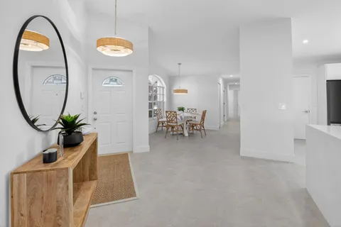 a kitchen with white cabinets stainless steel appliances and sink