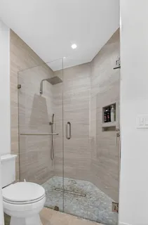 a bedroom with a bed and a ceiling fan
