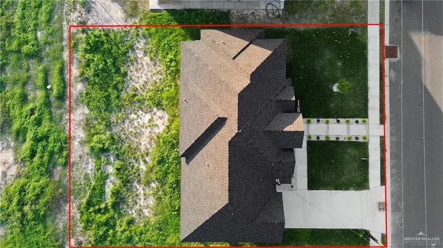 an aerial view of a house with a yard