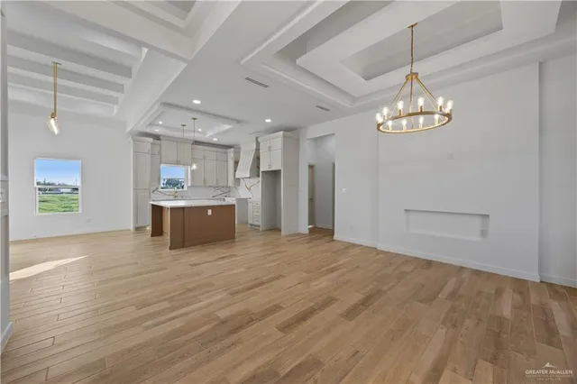 a view of a kitchen with a sink dishwasher a refrigerator and a stove top oven