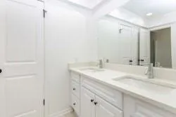 an empty room with a fan & a ceiling fan