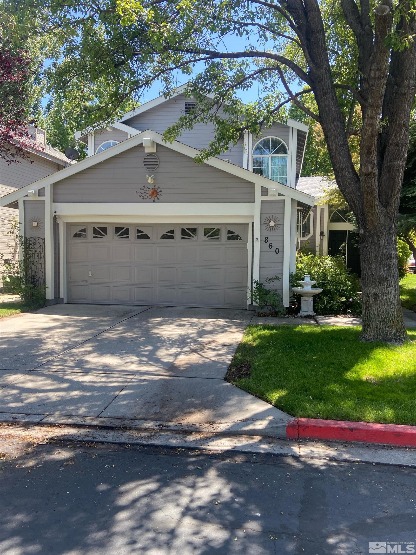 860 Swaledale Drive Reno, NV 89511 - Photo 1 of 19 a front view of a house with a garden and yard