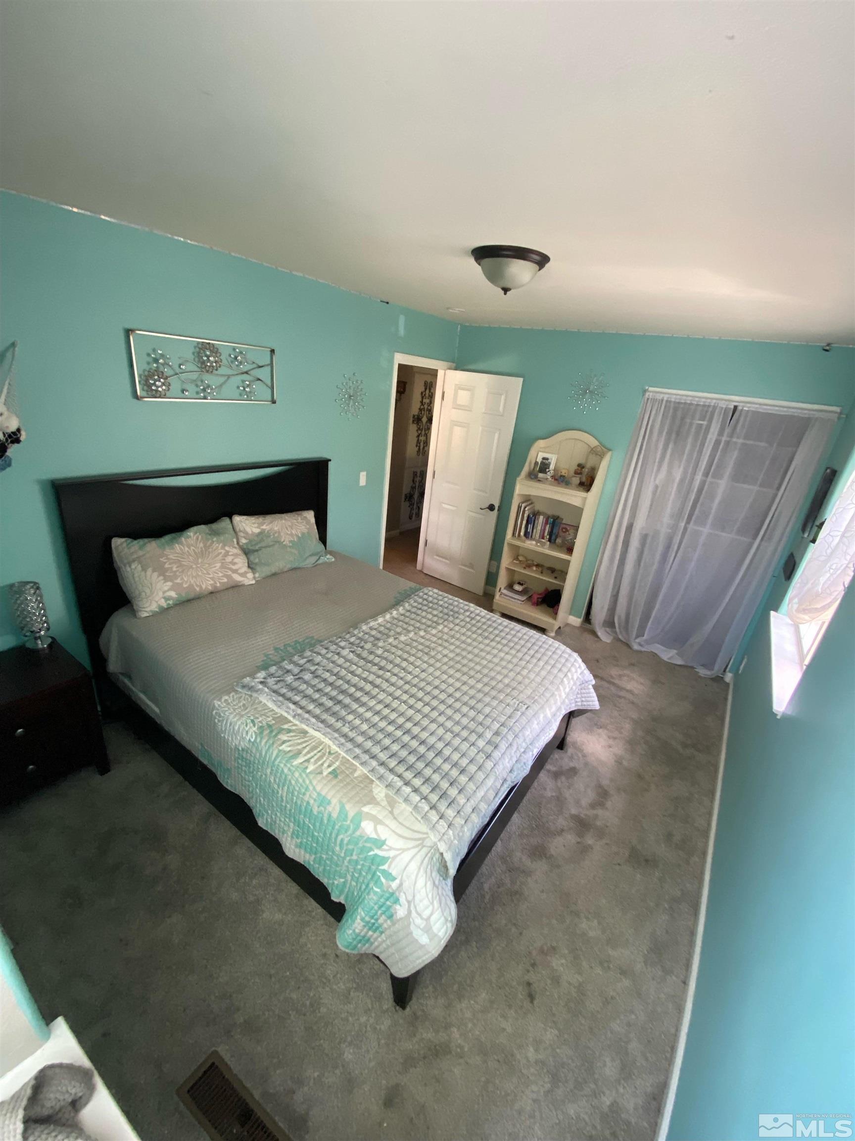 860 Swaledale Drive Reno, NV 89511 - Photo 19 of 19 a bed sitting in a bedroom next to a window