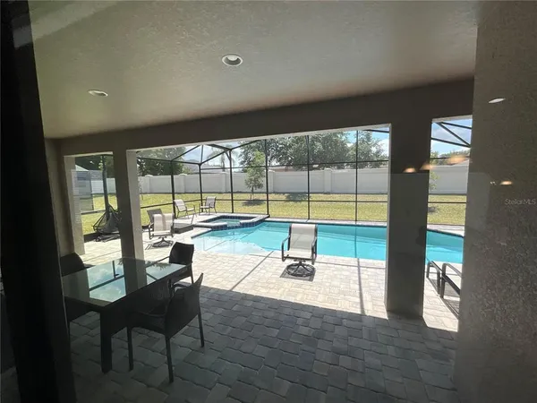 a view of a living room with furniture and floor to ceiling window