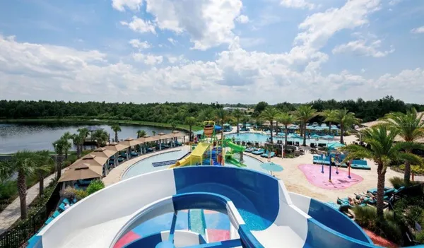 a bedroom with a bed lamp and window