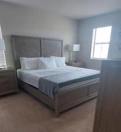 a bedroom with bed and a couch