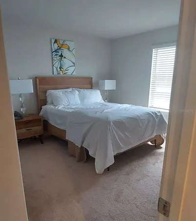 a bedroom with a bed and lamp