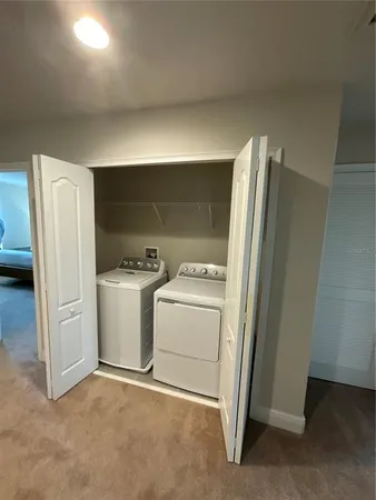 a bed room with a bed a couch and a flat screen tv