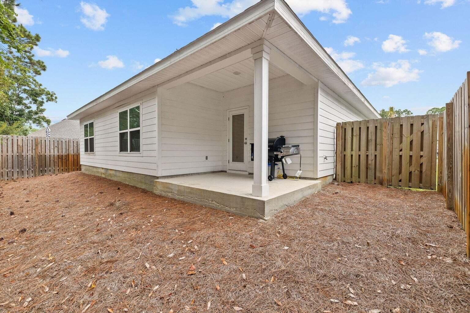 161 Southern Pnes Road Santa Rosa Beach, FL 32459 - Photo 13 of 20 a view of a house with backyard and wooden fence