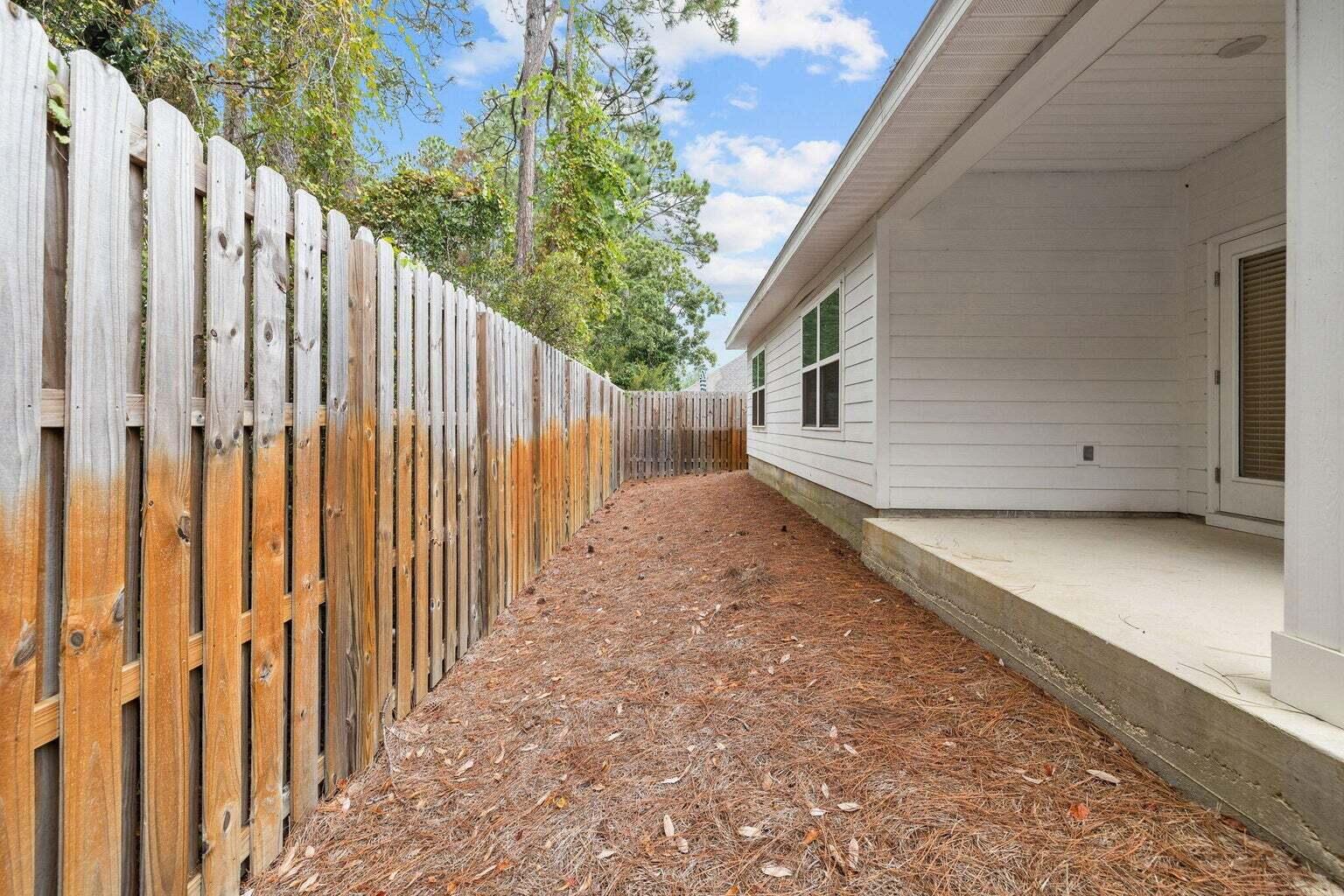161 Southern Pnes Road Santa Rosa Beach, FL 32459 - Photo 15 of 20 a view of a house with a backyard and wooden fence
