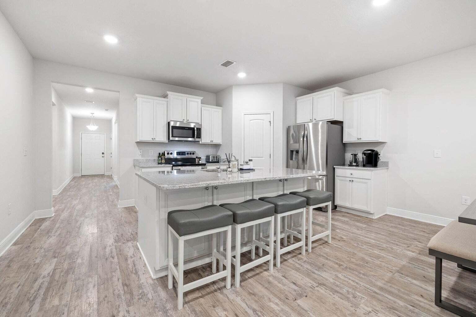 161 Southern Pnes Road Santa Rosa Beach, FL 32459 - Photo 10 of 20 a kitchen with stainless steel appliances a stove a sink refrigerator and a microwave