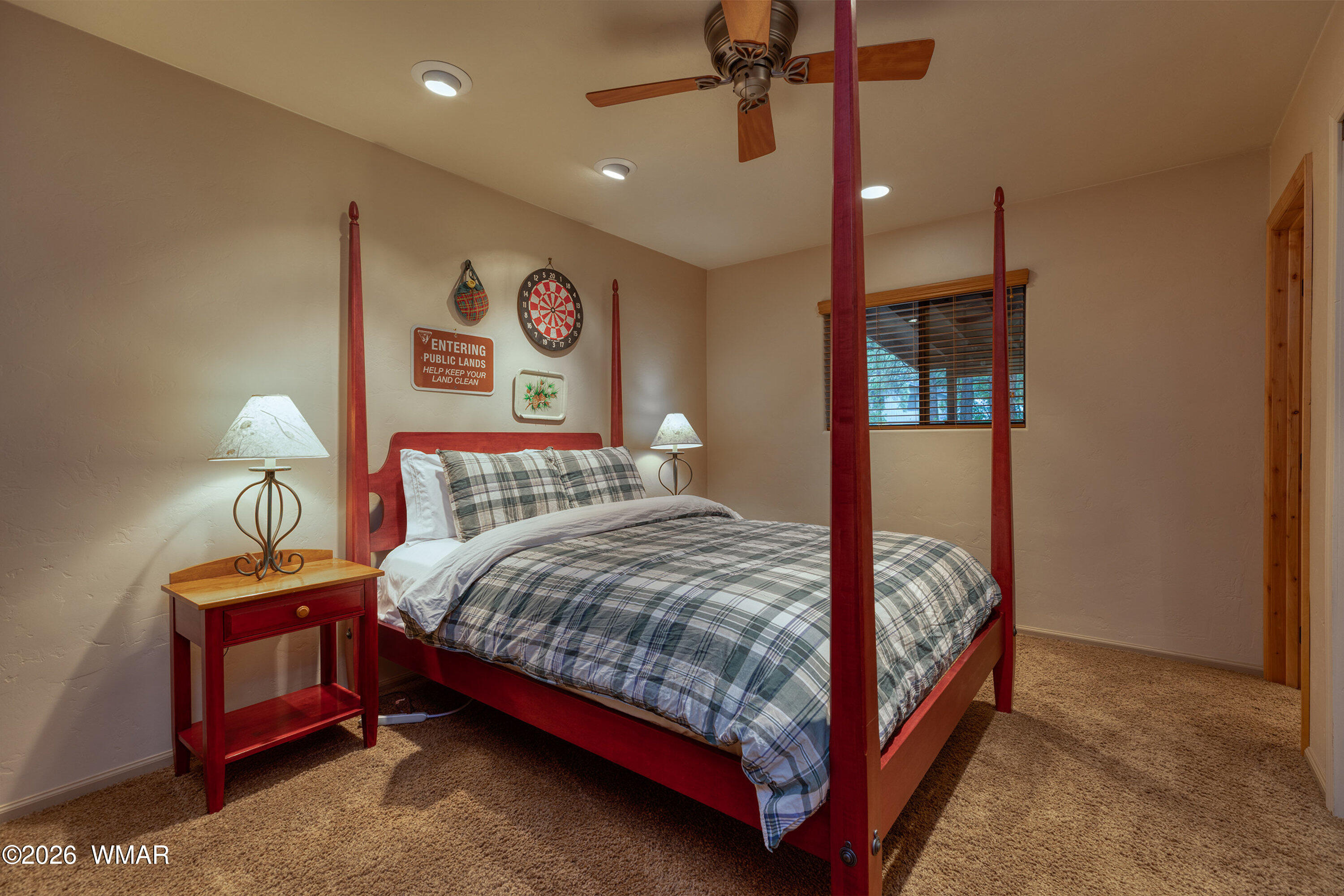 5155 Buck Springs Road Pinetop, AZ 85935 - Photo 26 of 37 a bedroom with a bed and lamp