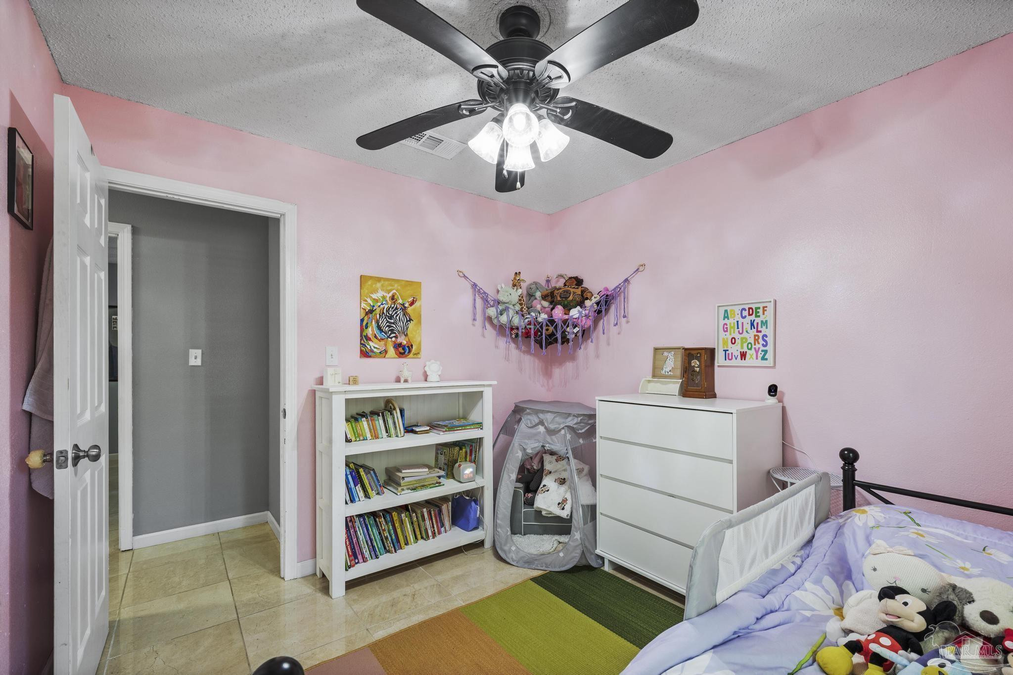 4281 Tomahawk Trail Milton, FL 32583 - Photo 22 of 42 a bedroom with furniture and a chandelier