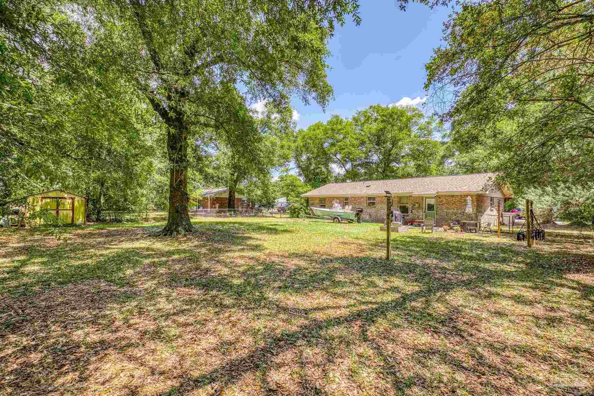 4281 Tomahawk Trail Milton, FL 32583 - Photo 36 of 42 a view of a house with a yard