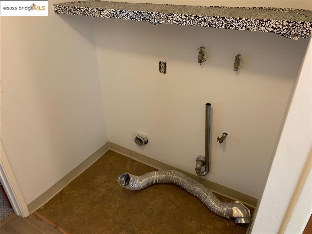 708 Solano Avenue, Unit D Albany, CA 94706 - Photo 21 of 23 Laundry area featuring baseboards