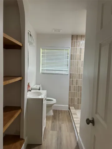 a bathroom with a sink a toilet and shower