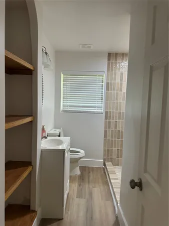a bathroom with a sink toilet and shower