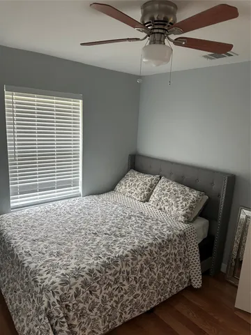 a bed sitting in a bedroom next to a window