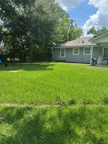 a front view of house with a garden