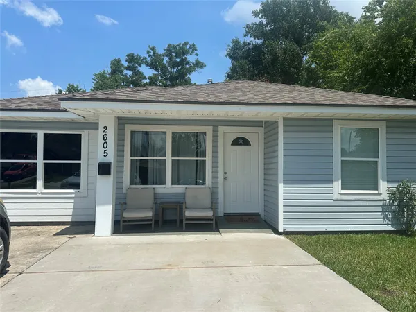 a front view of a house with a garden