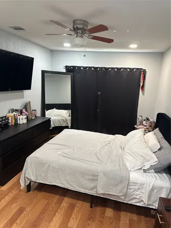 a bedroom with a bed and flat screen tv