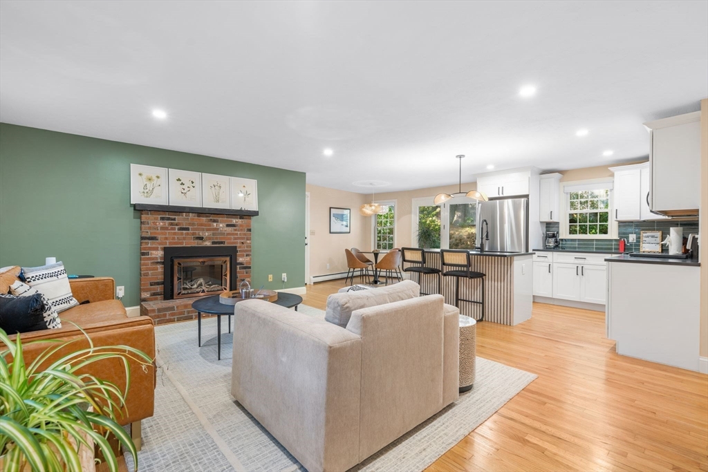 7 Hunter's Trail Sandwich, MA 02563 - Photo 11 of 27 a living room with furniture fireplace and a table