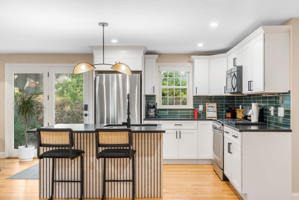 7 Hunter's Trail Sandwich, MA 02563 - Photo 12 of 27 a kitchen with stainless steel appliances granite countertop a stove a sink and a window