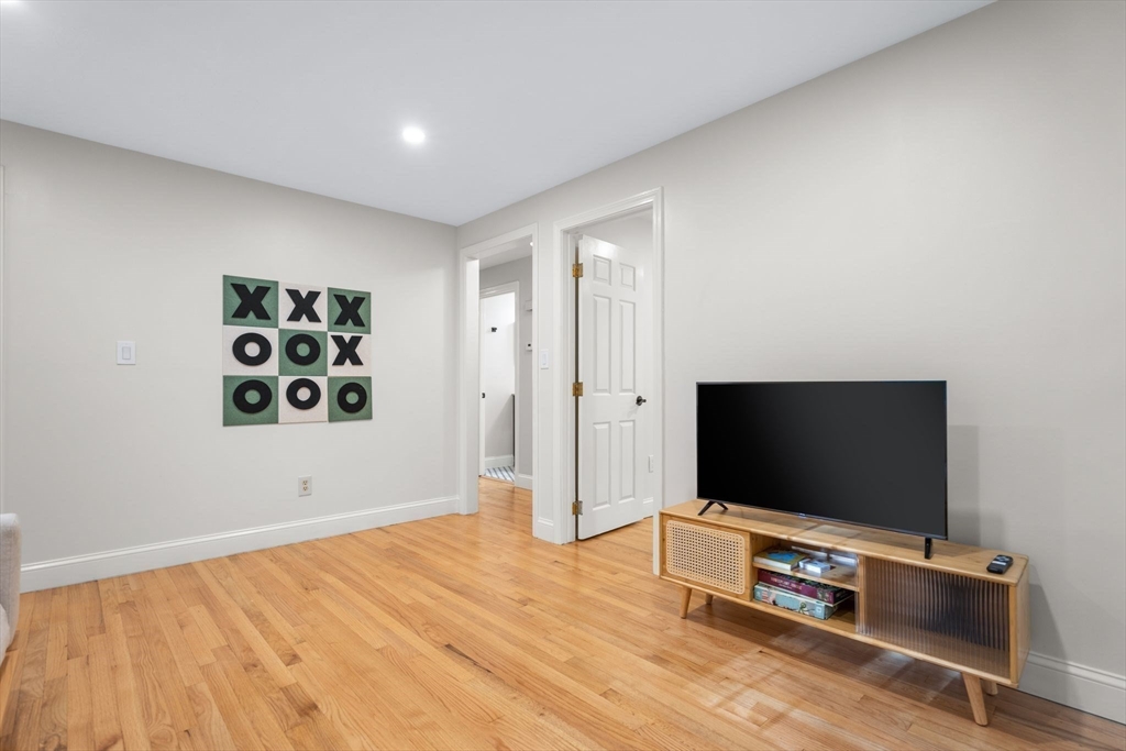 7 Hunter's Trail Sandwich, MA 02563 - Photo 15 of 27 a living room with flat screen tv and gym equipment
