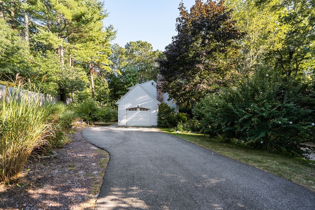 7 Hunter's Trail Sandwich, MA 02563 - Photo 2 of 27 a view of a garage with a tree