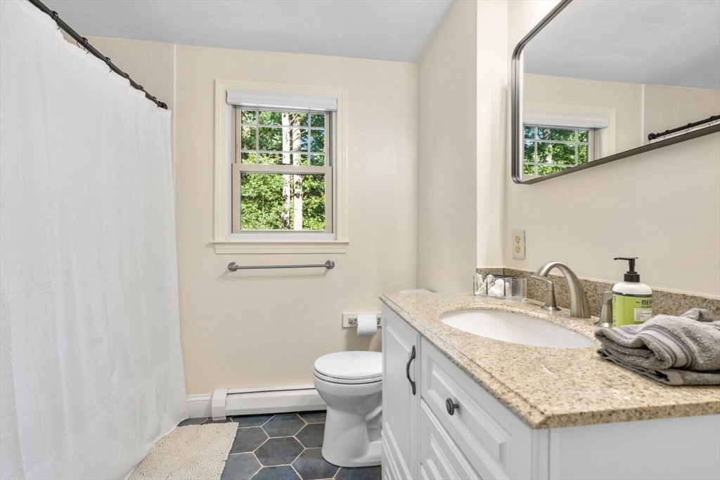 7 Hunter's Trail Sandwich, MA 02563 - Photo 22 of 27 a bathroom with a granite countertop sink a toilet and a window