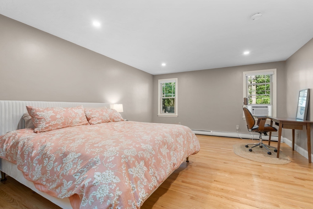 7 Hunter's Trail Sandwich, MA 02563 - Photo 23 of 27 a bedroom with a bed a table and chair