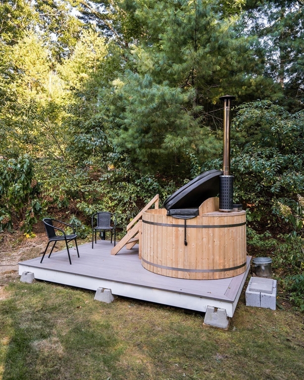 7 Hunter's Trail Sandwich, MA 02563 - Photo 27 of 27 a view of a roof deck with table and chairs with wooden fence