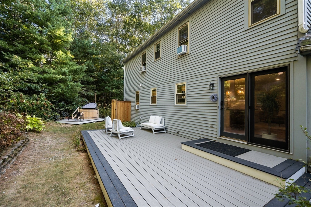 7 Hunter's Trail Sandwich, MA 02563 - Photo 3 of 27 a view of a patio with table and chairs with wooden floor and fence