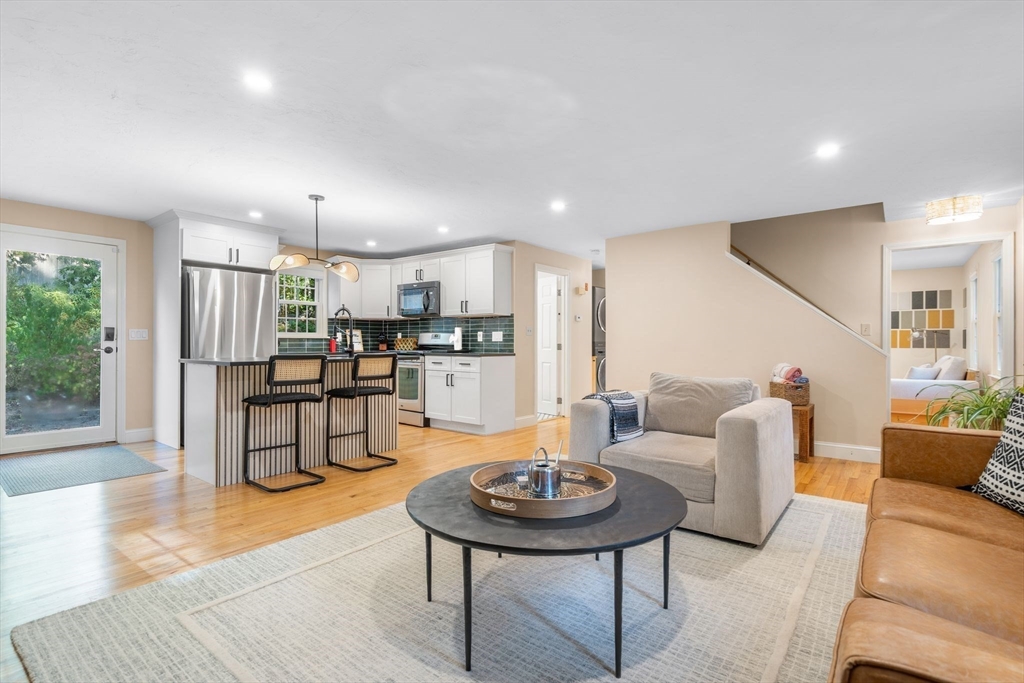 7 Hunter's Trail Sandwich, MA 02563 - Photo 10 of 27 a living room with kitchen furniture and kitchen view with wooden floor