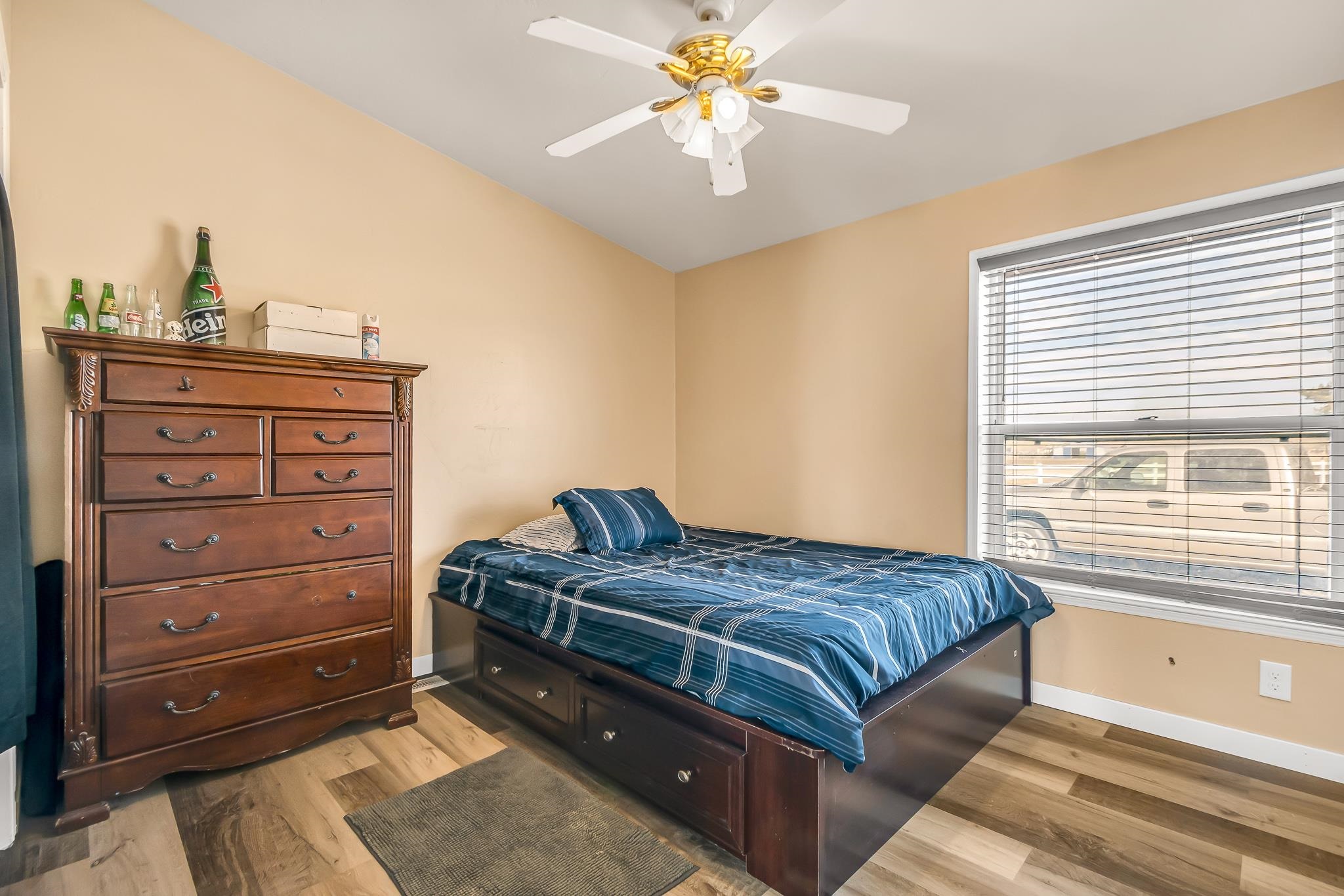 1825 M Road Fruita, CO 81521 - Photo 11 of 29 a bedroom with a bed and a chandelier