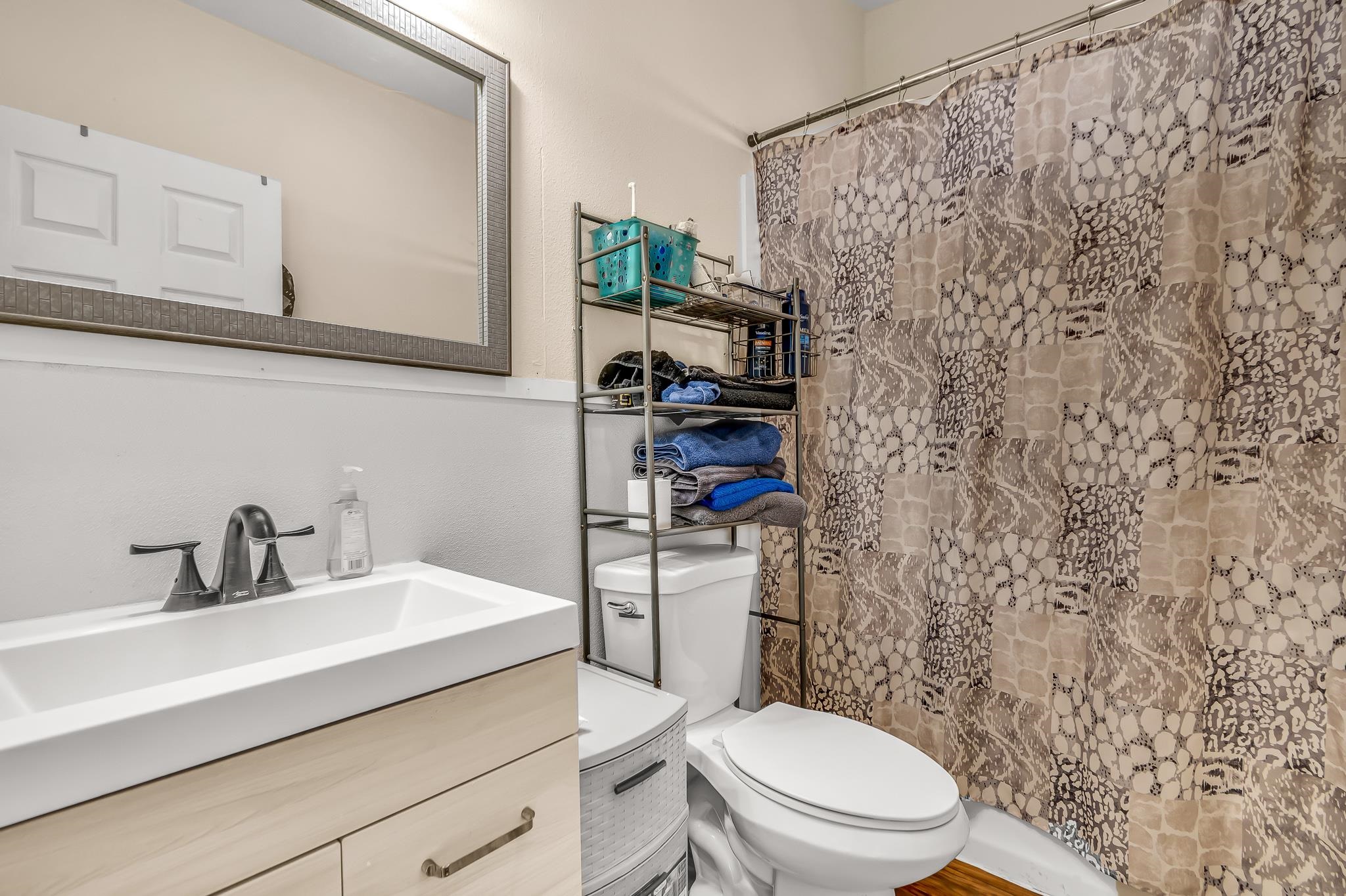 1825 M Road Fruita, CO 81521 - Photo 12 of 29 a bathroom with a sink a toilet and shower curtain