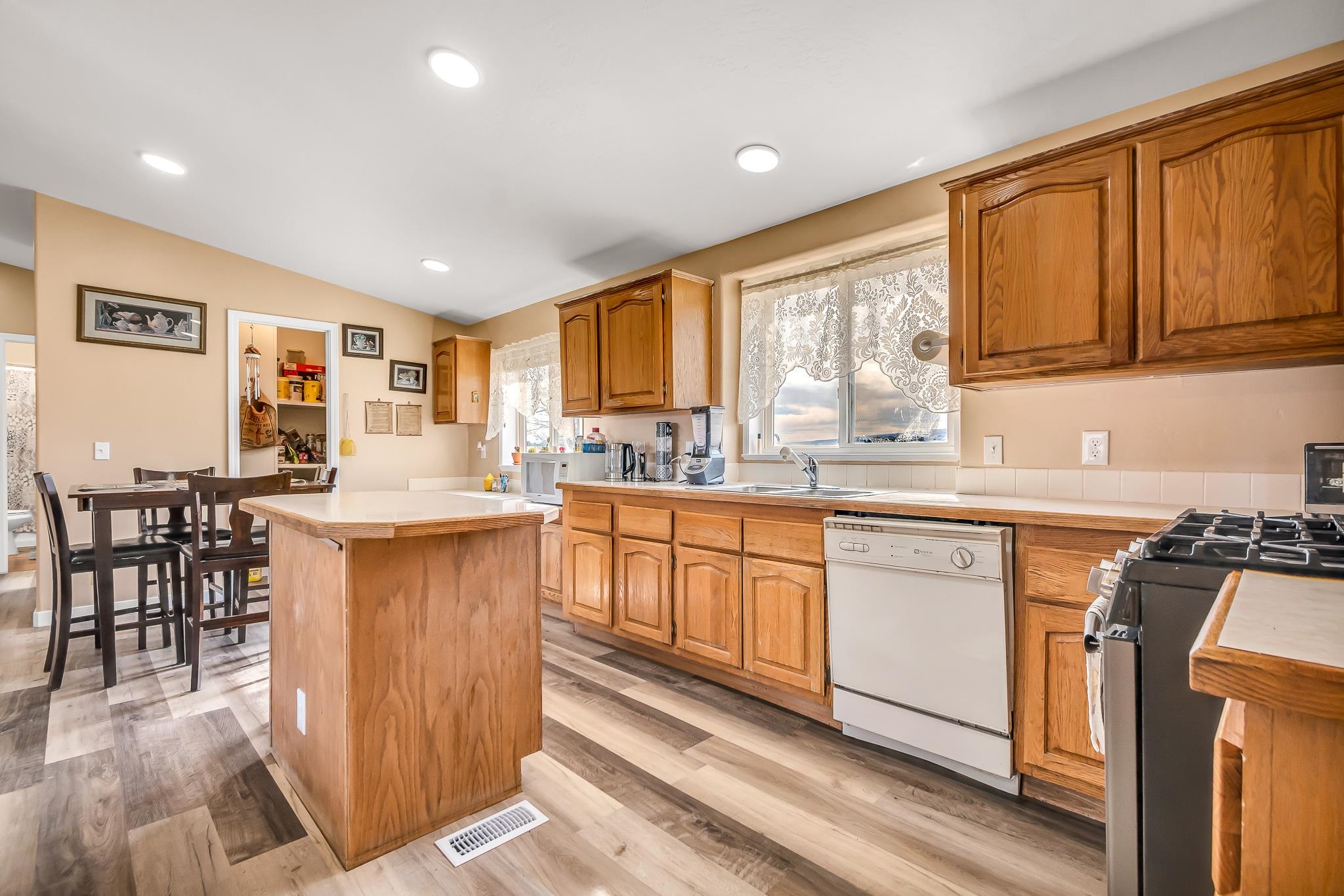 1825 M Road Fruita, CO 81521 - Photo 8 of 29 a kitchen with granite countertop a stove a sink a dining table and chairs