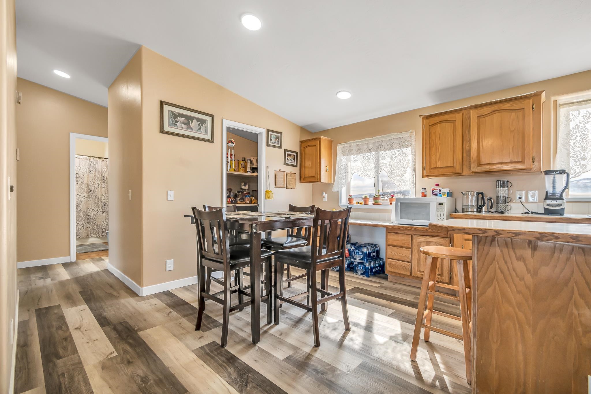 1825 M Road Fruita, CO 81521 - Photo 9 of 29 a kitchen with stainless steel appliances granite countertop dining table chairs and a refrigerator