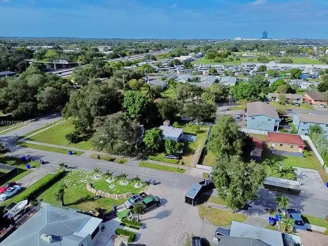 an aerial view of a houses with a yard