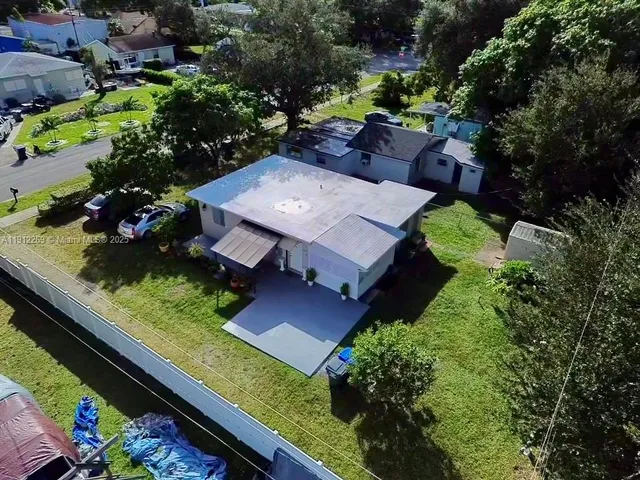an aerial view of a house with a garden and plants